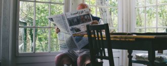Elderly man reading the paper