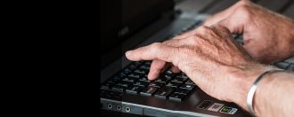 Pair of hands typing on a computer keyboard