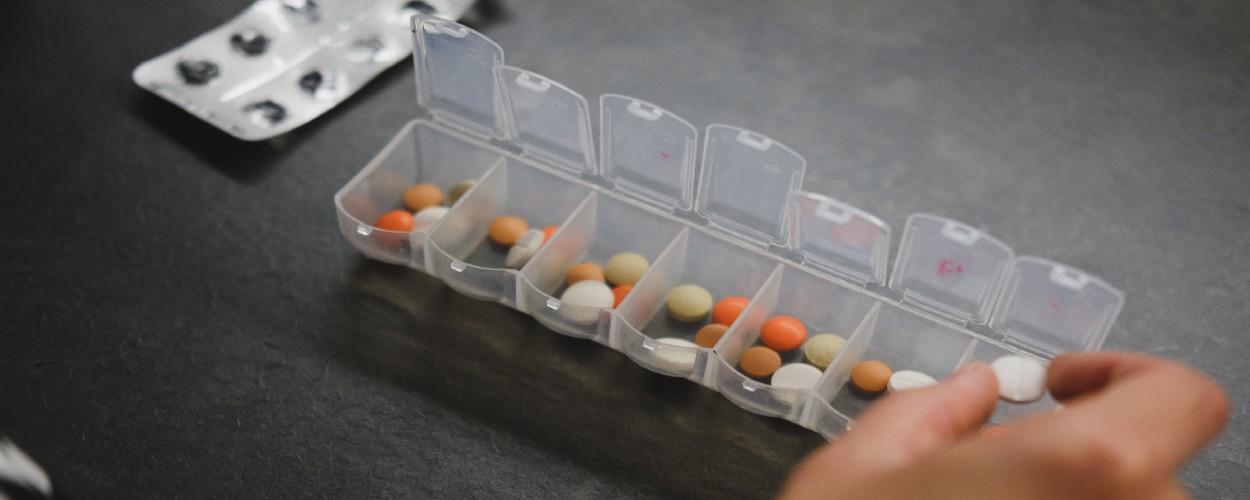 Person Using Medication Pill Box