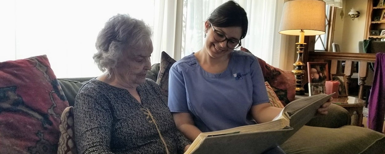 Elderly lady and nurse reading