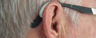 Elderly man wearing a hearing aid