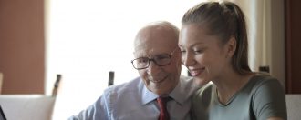 elderly man planning his digital legacy with support from daughter