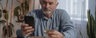 elderly man doing online banking on his smartphonephone